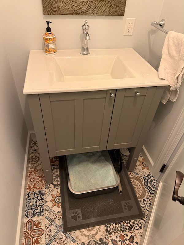 Bathroom vanity and patterned tile floor