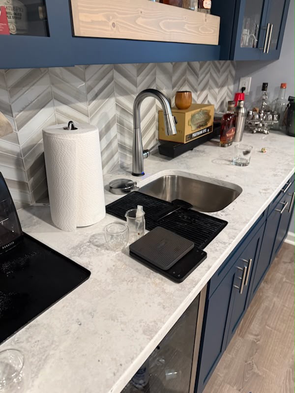 Clean kitchen sink and navy cabinetry